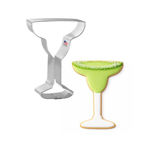 Metal cookie cutter shaped like a margarita glass with a green rim on a white background