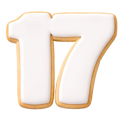 Cookie shaped like number 17 white filling on a marble surface