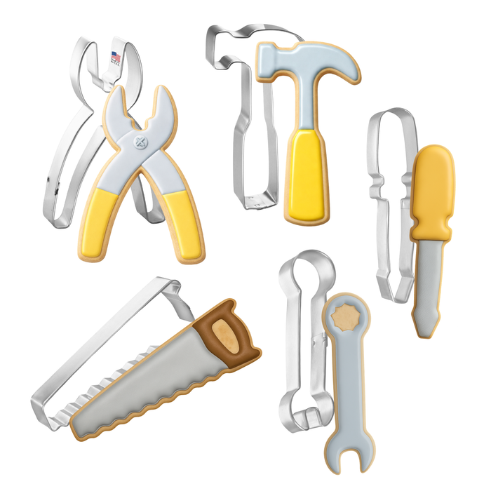 Set of cookie cutters shaped like tools on a white background